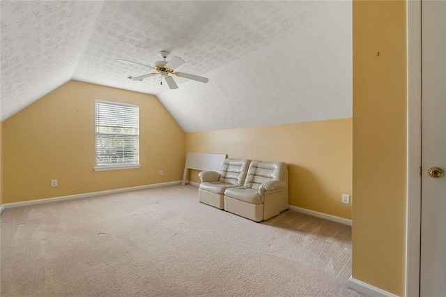 additional living space featuring lofted ceiling, light colored carpet, ceiling fan, and a textured ceiling