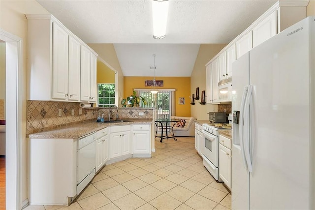 kitchen featuring white cabinets, vaulted ceiling, and white appliances