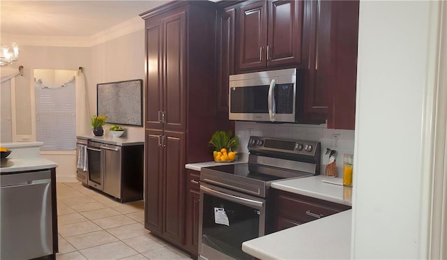 kitchen with decorative backsplash, stainless steel appliances, crown molding, light tile patterned flooring, and a notable chandelier