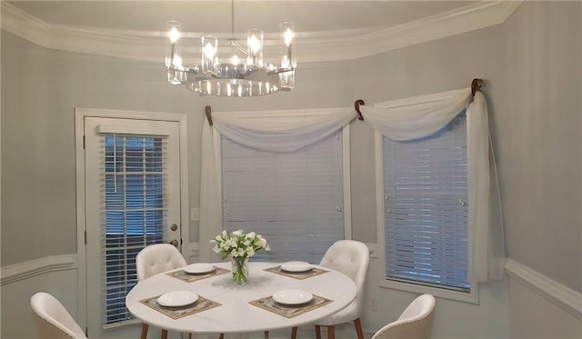 dining room with an inviting chandelier and ornamental molding