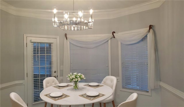 dining space featuring an inviting chandelier and crown molding