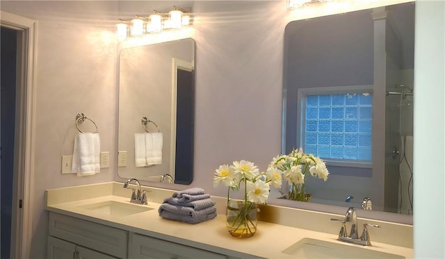 full bath featuring double vanity and a sink