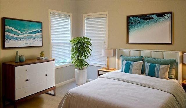 bedroom featuring carpet and baseboards