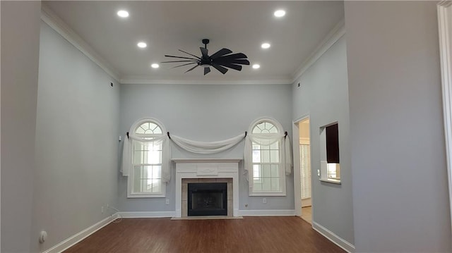 unfurnished living room featuring ornamental molding, wood finished floors, and plenty of natural light