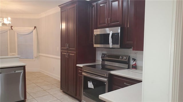 kitchen with decorative backsplash, ornamental molding, light tile patterned flooring, a notable chandelier, and appliances with stainless steel finishes