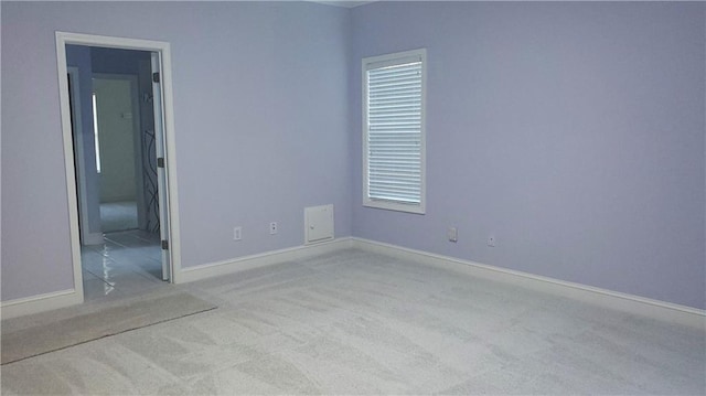 unfurnished room with light colored carpet