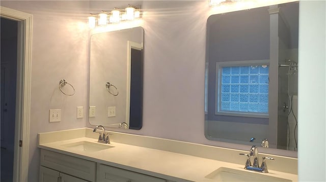 full bath with double vanity and a sink
