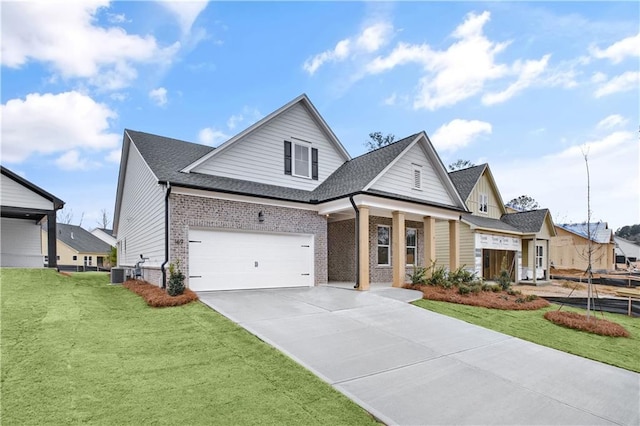 view of front of house with an attached garage, central air condition unit, brick siding, concrete driveway, and a front lawn