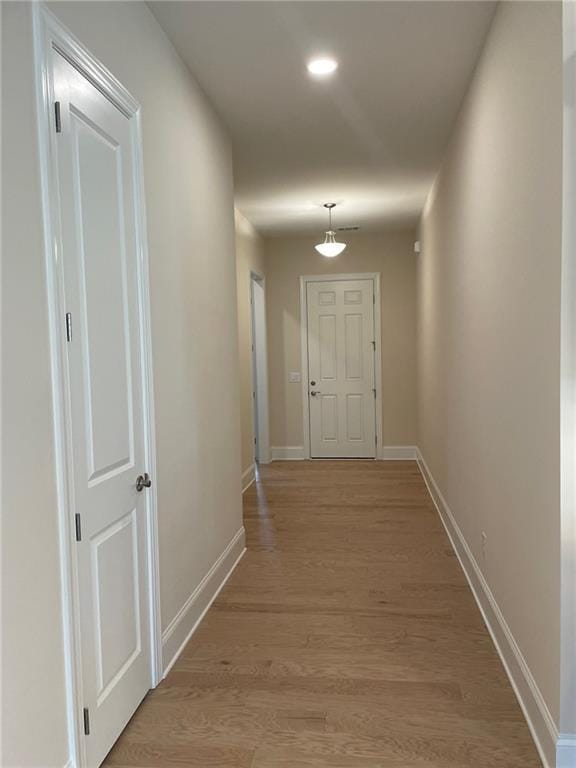 hall with light hardwood / wood-style flooring