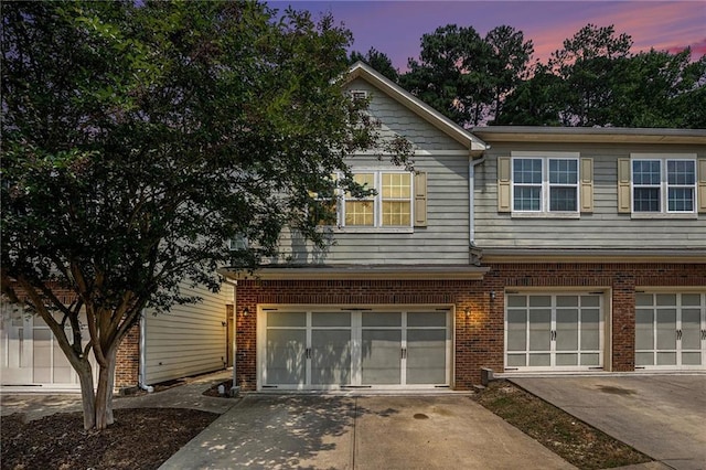 876 Ivydale Ln Unit 63, Lawrenceville, GA 30045 - view of front of house featuring a garage, driveway, and brick siding