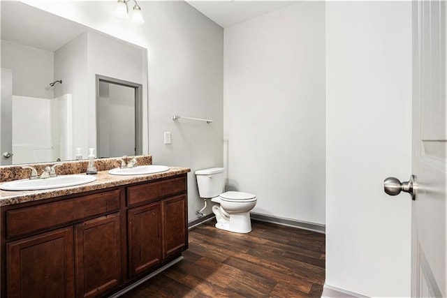 876 Ivydale Ln Unit 63, Lawrenceville, GA 30045 - bathroom featuring double vanity, toilet, wood finished floors, a shower, and baseboards