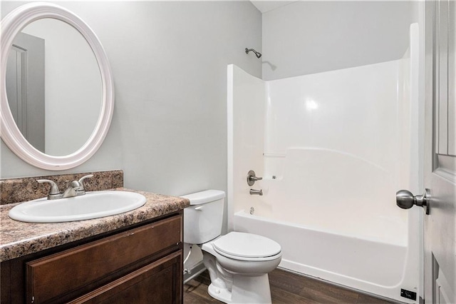 876 Ivydale Ln Unit 63, Lawrenceville, GA 30045 - bathroom featuring vanity, toilet, wood finished floors, and washtub / shower combination