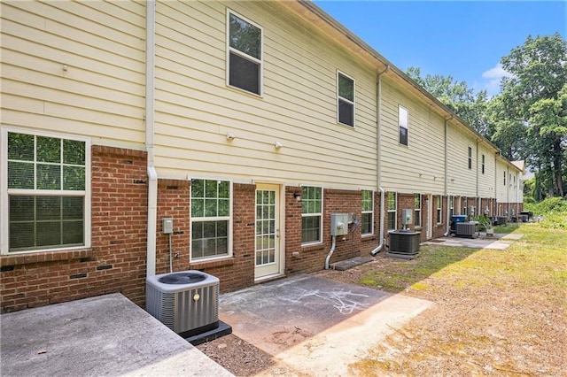876 Ivydale Ln Unit 63, Lawrenceville, GA 30045 - back of house with cooling unit, a patio, and brick siding