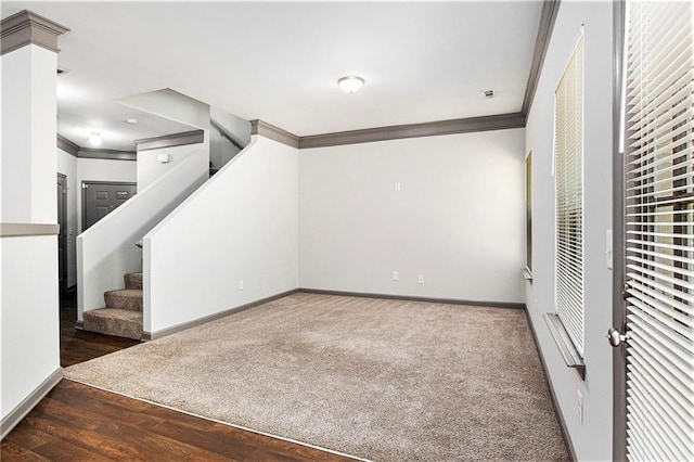 876 Ivydale Ln Unit 63, Lawrenceville, GA 30045 - unfurnished living room with crown molding, baseboards, stairs, wood finished floors, and carpet floors