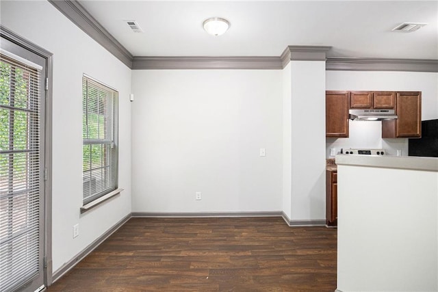 876 Ivydale Ln Unit 63, Lawrenceville, GA 30045 - kitchen with under cabinet range hood, ornamental molding, dark wood finished floors, black fridge, and baseboards