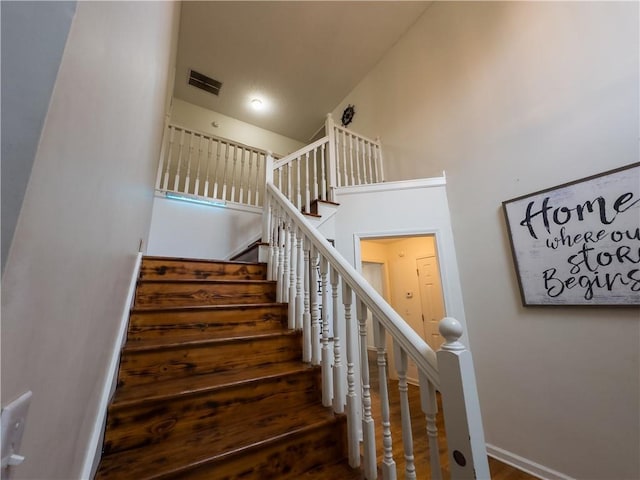 111 Bexley Ln, Douglasville, GA 30134 - stairway featuring wood finished floors, baseboards, and a towering ceiling