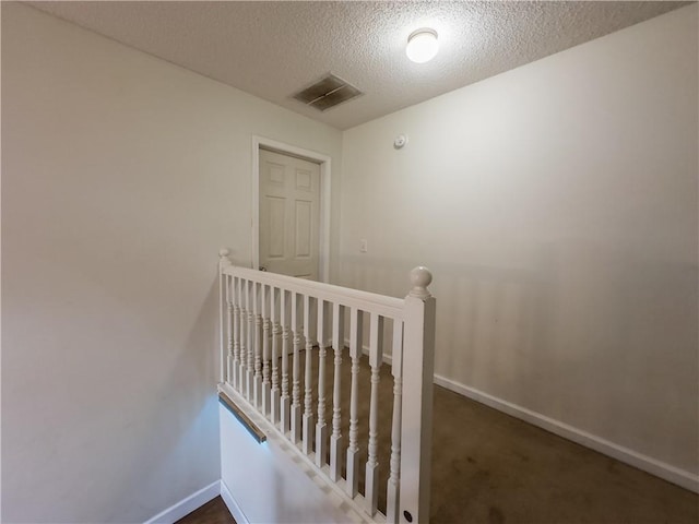 111 Bexley Ln, Douglasville, GA 30134 - staircase featuring baseboards, a textured ceiling, and carpet flooring