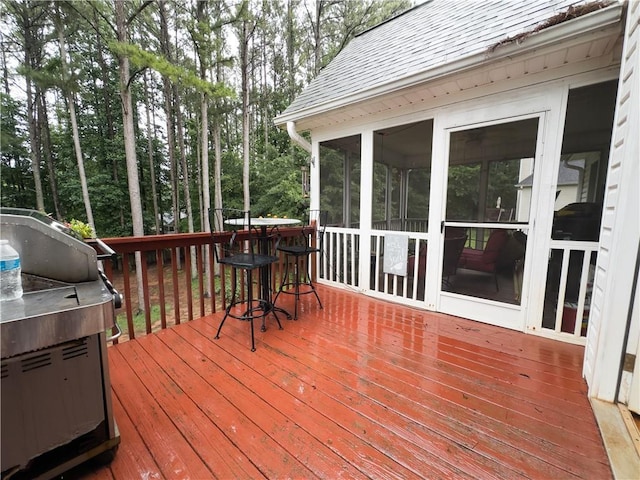 111 Bexley Ln, Douglasville, GA 30134 - wooden deck featuring view of scattered trees and a sunroom