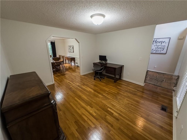 111 Bexley Ln, Douglasville, GA 30134 - office area featuring arched walkways, wood finished floors, and a textured ceiling