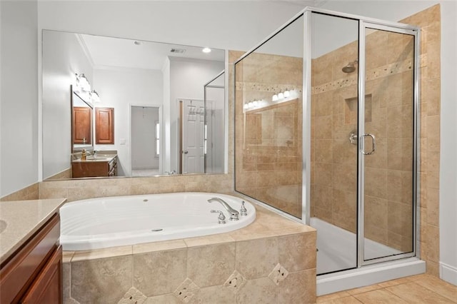 bathroom with a bath, a stall shower, tile patterned flooring, and vanity