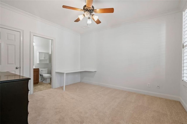 unfurnished bedroom with crown molding, ensuite bathroom, light carpet, ceiling fan, and baseboards