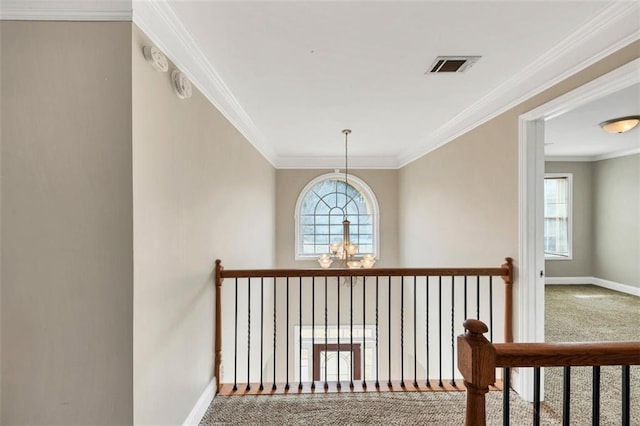 hallway featuring an inviting chandelier, ornamental molding, and carpet flooring