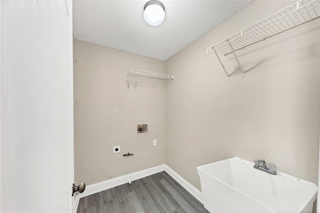 laundry area featuring hookup for a washing machine, sink, dark hardwood / wood-style floors, and hookup for an electric dryer