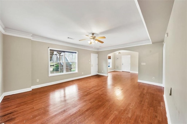 empty room featuring hardwood / wood-style flooring, ornamental molding, and ceiling fan