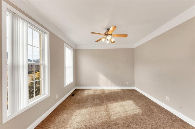 unfurnished room with ornamental molding, carpet flooring, and ceiling fan