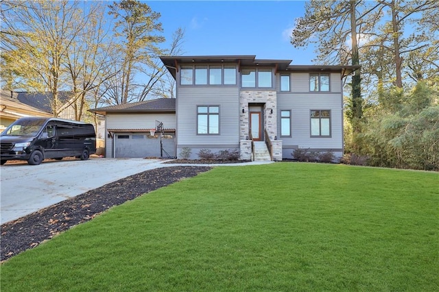 view of front of home featuring a garage and a front lawn