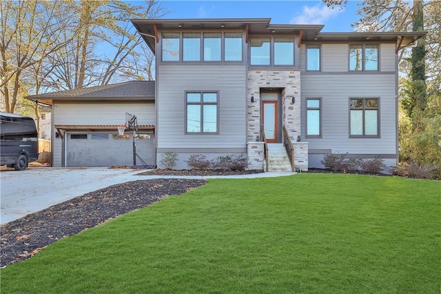 view of front of house with a front yard and a garage