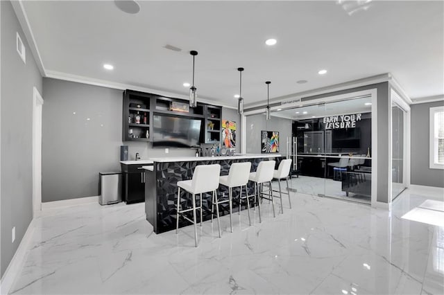 kitchen featuring crown molding, light tile flooring, a spacious island, hanging light fixtures, and a kitchen bar