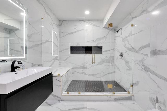 bathroom featuring tile floors, tile walls, a shower with shower door, and vanity