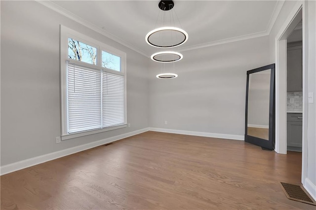 interior space with ornamental molding and wood-type flooring