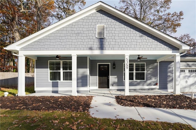 view of front of property featuring a porch, a garage, and ceiling fan