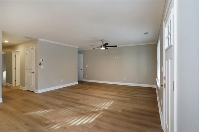 unfurnished room featuring ornamental molding, light hardwood / wood-style floors, and ceiling fan