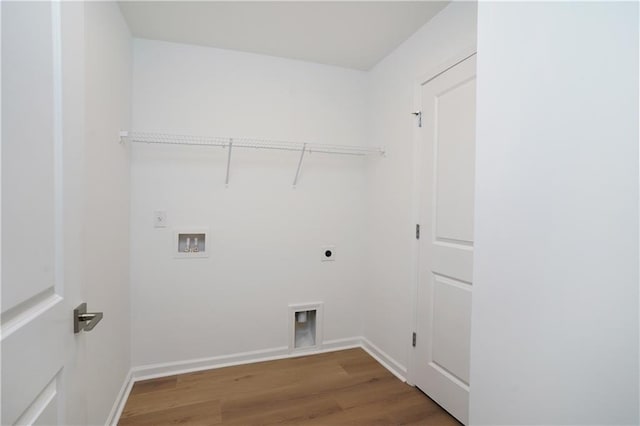 washroom featuring hookup for a washing machine, hardwood / wood-style floors, and electric dryer hookup