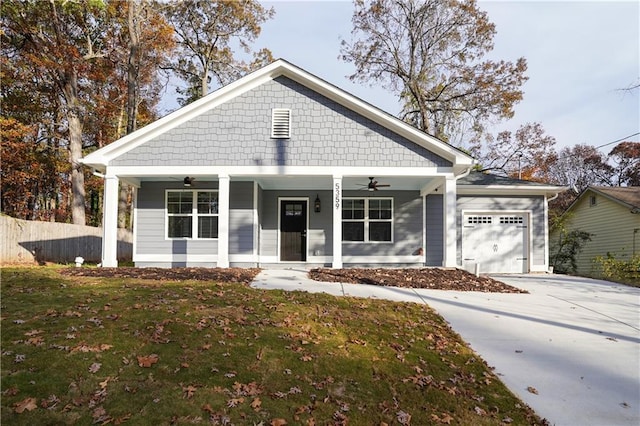 view of front of house featuring ceiling fan, a front lawn, covered porch, and a garage