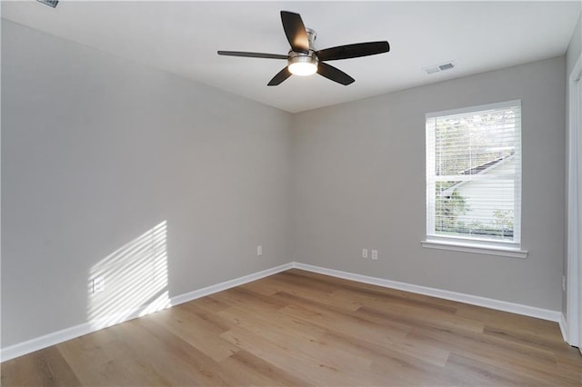 empty room with light hardwood / wood-style flooring and ceiling fan