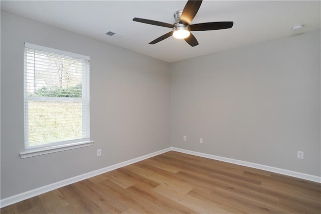 spare room with ceiling fan and light wood-type flooring