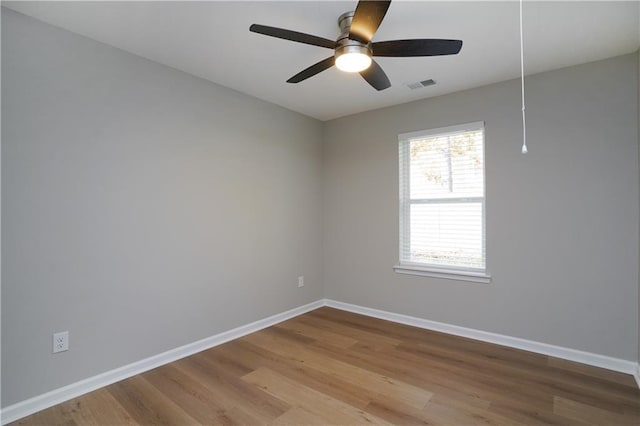 empty room featuring ceiling fan and light hardwood / wood-style floors