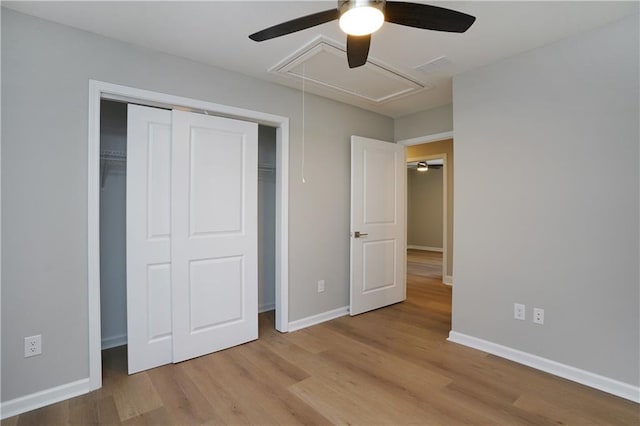 unfurnished bedroom featuring a closet, ceiling fan, and light wood-type flooring