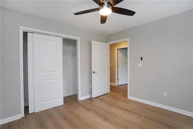 unfurnished bedroom with ceiling fan, light hardwood / wood-style floors, and a closet