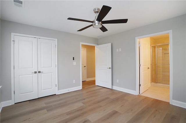 unfurnished bedroom with ceiling fan, connected bathroom, light hardwood / wood-style floors, and a closet