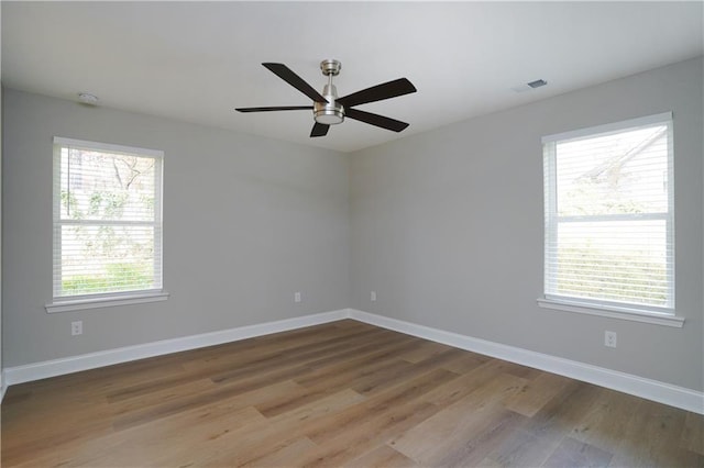 unfurnished room featuring ceiling fan and hardwood / wood-style floors