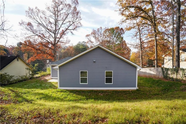 view of side of home with a lawn