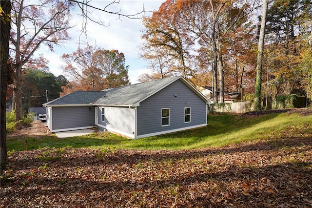 view of home's exterior with a yard