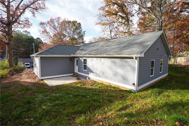 rear view of house featuring a yard and a patio area