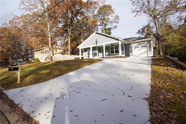 single story home with a garage, a front lawn, and a porch