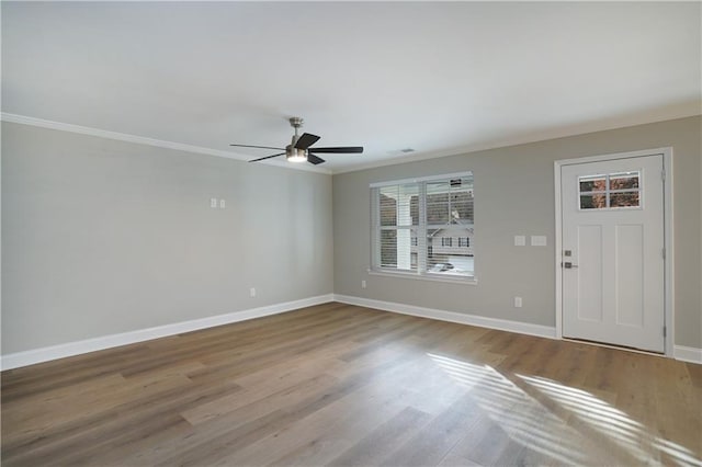 foyer entrance with crown molding, light hardwood / wood-style flooring, and ceiling fan